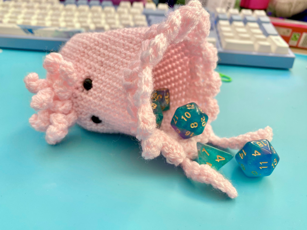 Pink dice bag spilling dice